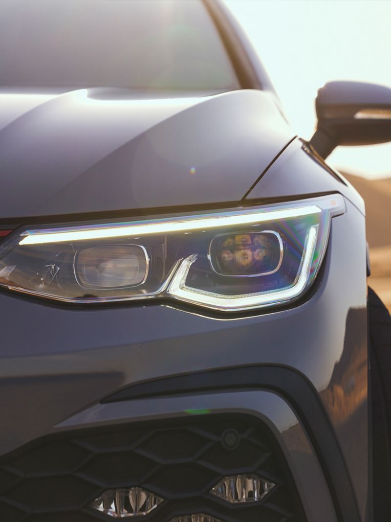 Close up view showing the illuminated LED Daytime Running Lights of a Golf GTI headlight.