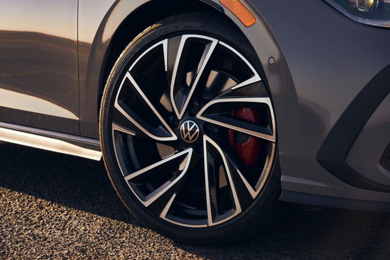 Close up of a front wheel on a Golf GTI shown in Moonstone Gray.