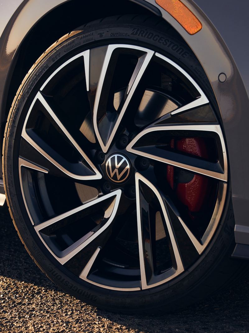 Close up of a front wheel on a Golf GTI shown in Moonstone Gray.