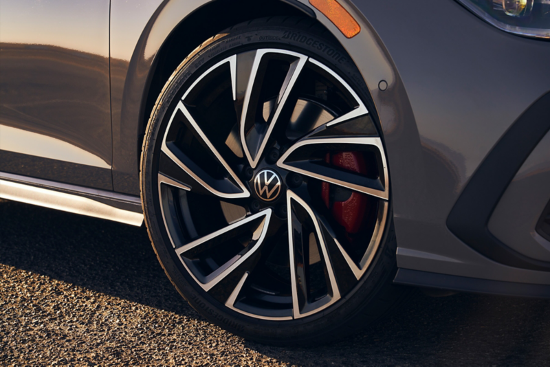 Close up of a front wheel on a Golf GTI shown in Moonstone Gray.