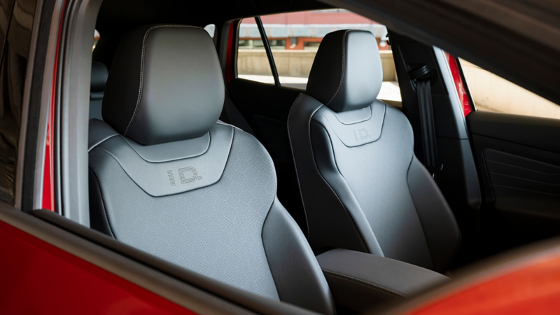 An interior shot of the front seats of an ID.4 shown in the Galaxy interior as seen through the passenger window.