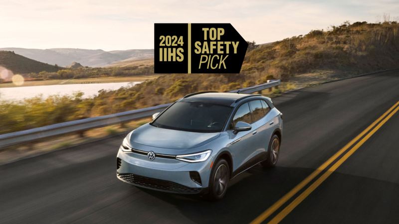 Front view of an ID.4 shown in Arctic Blue Metallic driving with mountains and a lake in the background with a 2024 IIHS TOP SAFETY PICK graphic superimposed on image.