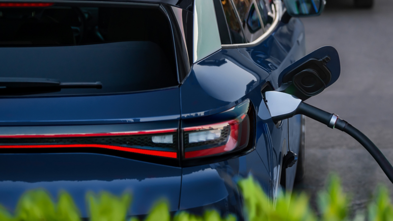 ID.4 shown in Mountain Lake Blue Metallic parked at a charging facility