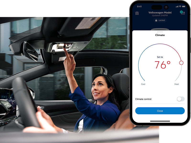 Interior vehicle shot of the front passenger interacting with the overhead controls. The MyVW app is displayed on a superimposed mobile phone.