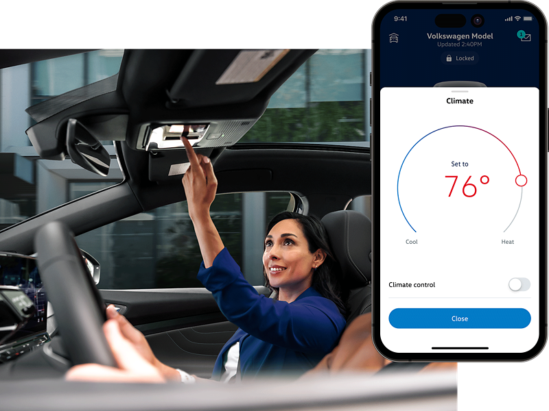 Interior vehicle shot of the front passenger interacting with the overhead controls. The MyVW app is displayed on a superimposed mobile phone.