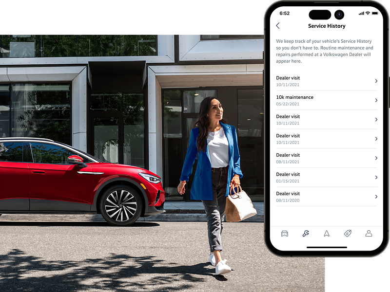 Street level shot of a woman walking away from a parked ID.4 SUV in Aurora Red Metallic. The MyVW app is displayed on a superimposed mobile phone.