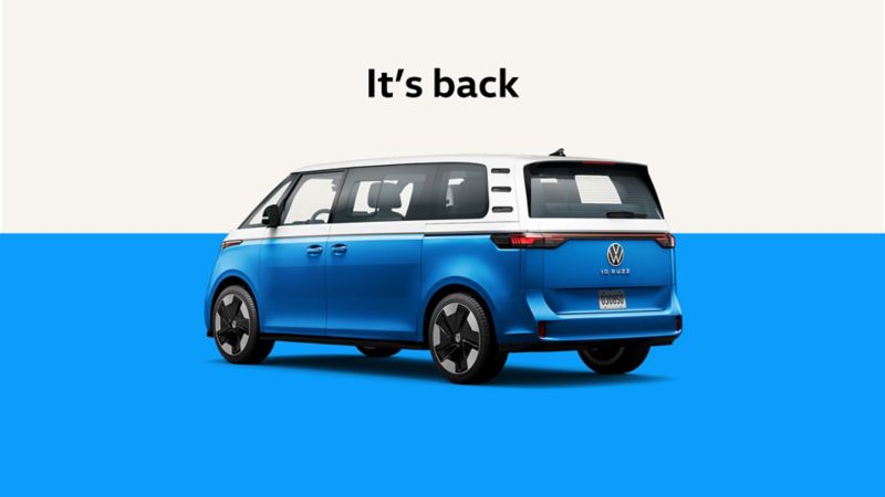 An image showing a ¾ rear view of the ID. Buzz in Cabana Blue Metallic in front of a two-tone white and blue background. The words “It’s back” are displayed above the vehicle.