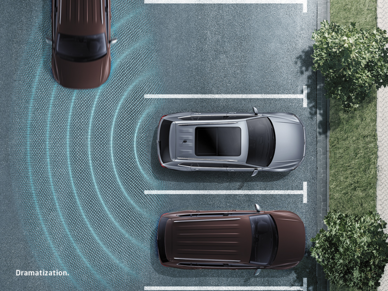 Glowing lines emit from the rear bumper of a vehicle, helping to illustrate obstacles.