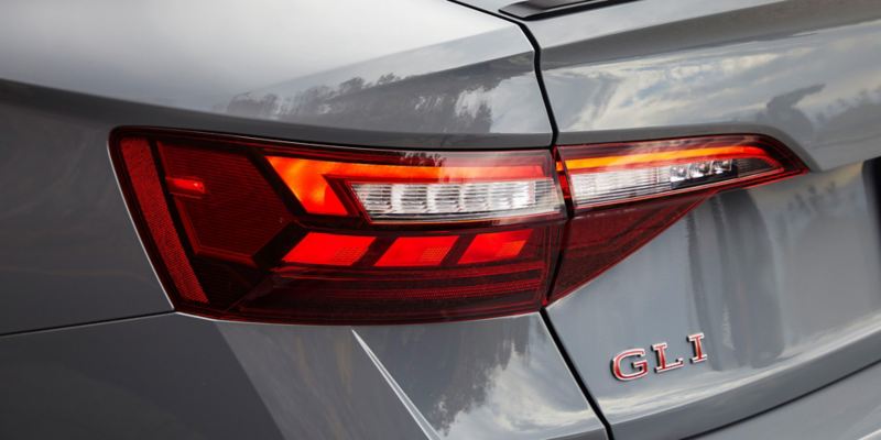 Close-up of left LED taillight and GLI badging on trunk.