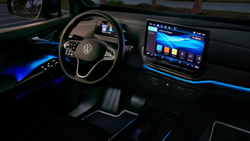 A close-up view of an ID.4 steering wheel and center display showing the adjustable ambient lighting screen. 
