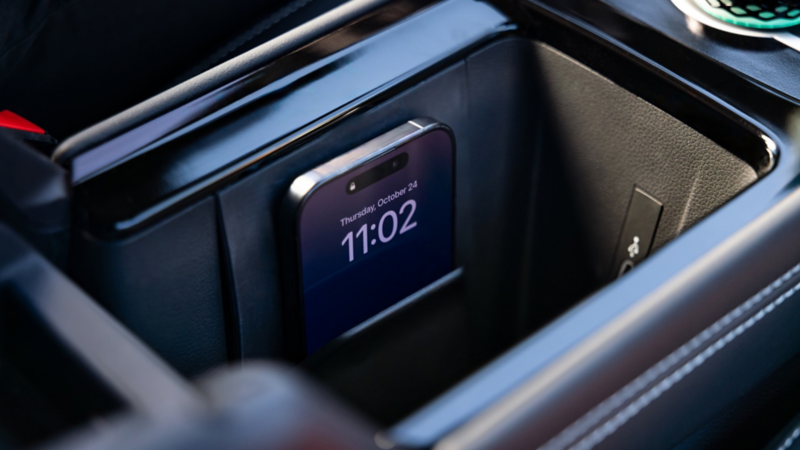 A compatible cell phone charges using the wireless charger in a Tiguan.