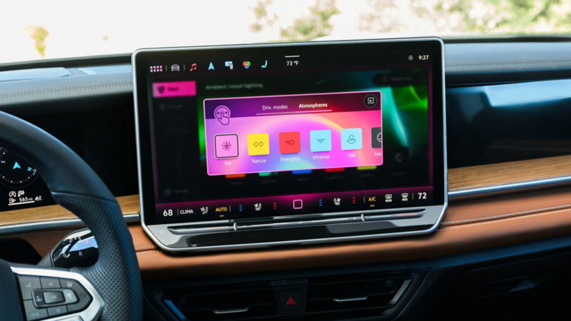 The interior of a Tiguan showing the available 15" center touchscreen display with the available Atmospheres mood selection screen options shown.