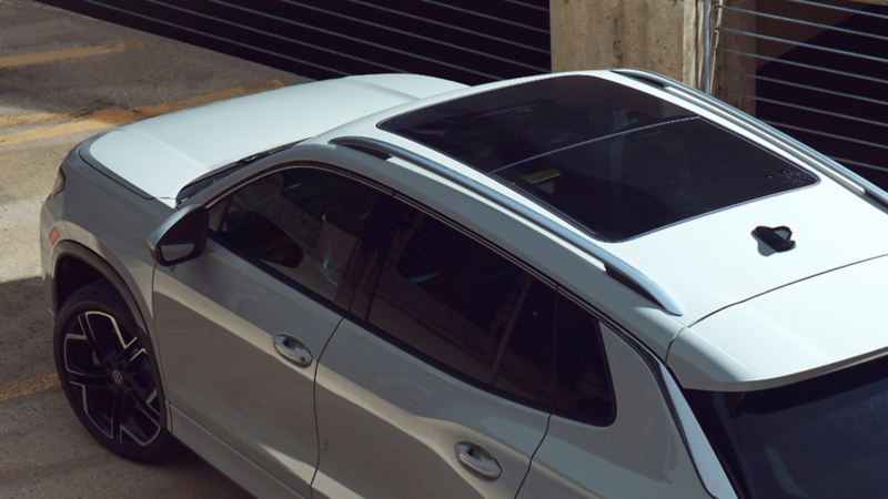 Overhead view of a Tiguan shown in Sandstone parked in a modern industrial parking garage.