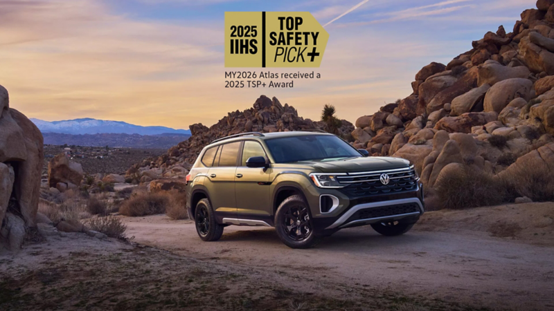 Atlas shown in Avocado Green Metallic parked in a desert setting with a safety rating icon overlayed at the top of the image.