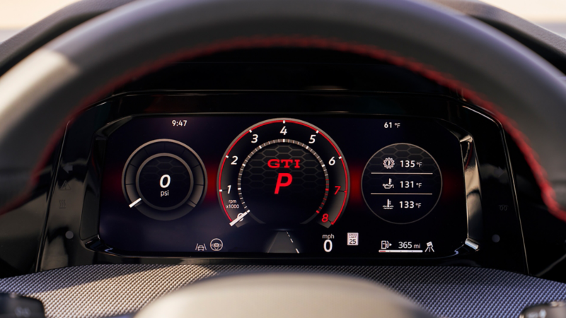 Close-up of the Golf GTI digital instrument cluster showing the tachometer, boost pressure, coolant temperatures, and range.