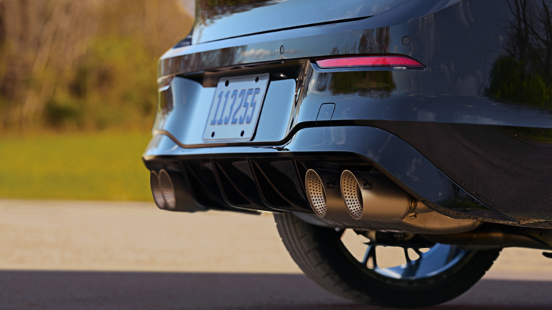Close up view of the rear bumper of a Golf R shown in Mythos Black Metallic.