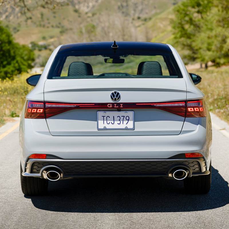 Rear view of a Jetta GLI shown in Monument Gray parked on a mountain road.