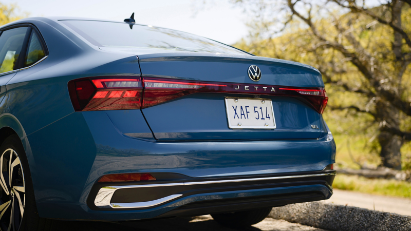 Close up rear view of a Jetta shown in Monterey Blue Pearl showing the LED taillights