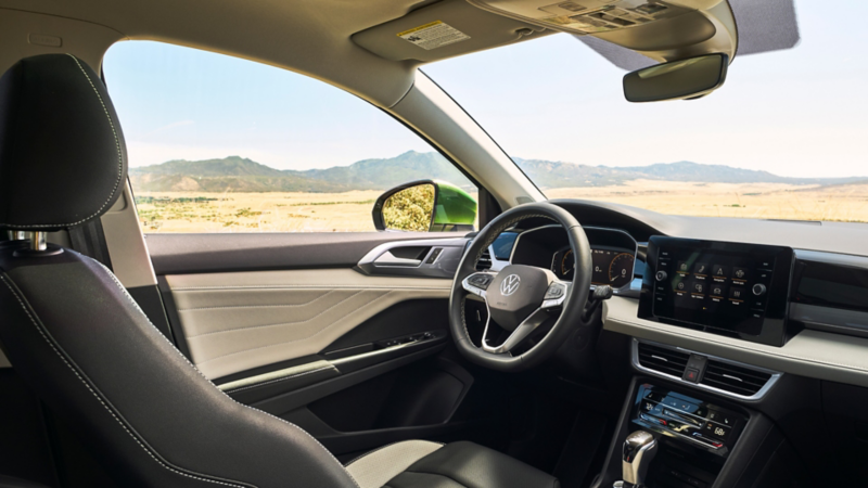 Interior view of a Taos with a mountainous landscape seen through the windows.