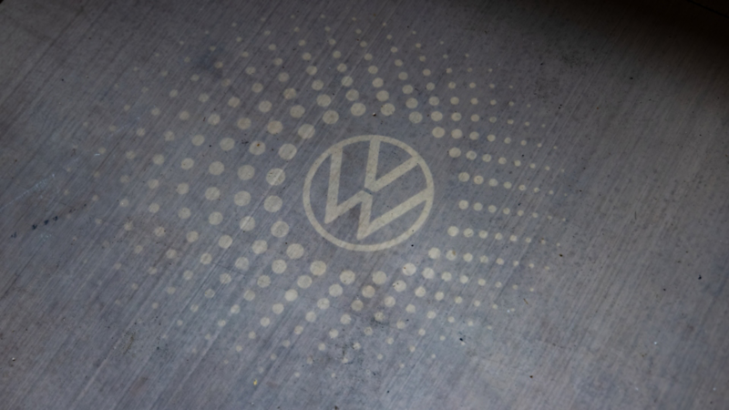 The VW logo is projected on the ground by the available VW logo puddle lights on side mirrors.