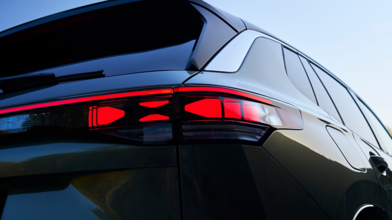 Close up view showing the LED taillights of a Tiguan shown in Avocado Green Metallic.