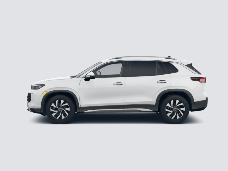 Profile view of a Tiguan shown in Pure White parked on a gray background.