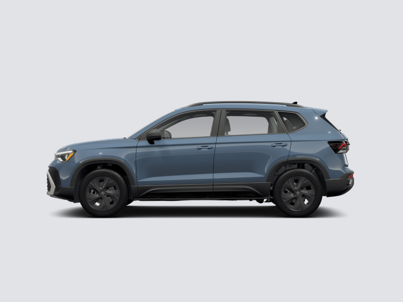 Profile view of a Taos shown in Monterey Blue Pearl parked on a gray background.