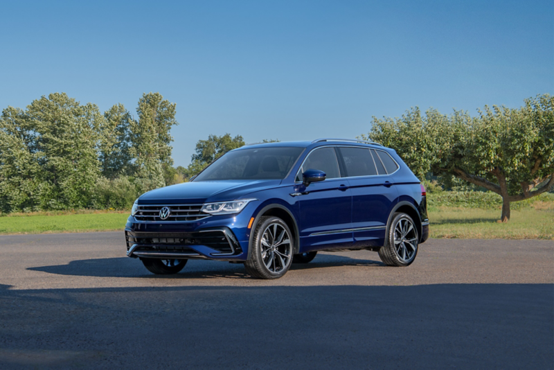 A Tiguan shown in Atlantic Blue Metallic is parked at an apple farm.