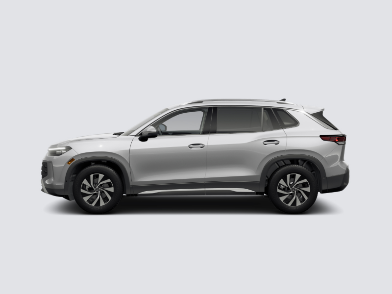 Profile view of a 2025 Tiguan shown in Pyrite Silver Metallic parked on a gray background.