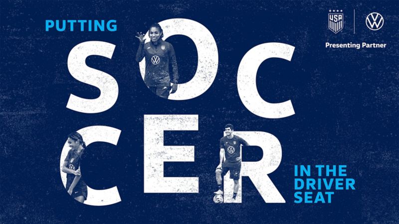An image of a blue background with the words “Putting Soccer in the Driver Seat” Three women’s soccer players are peeking out of the word “Soccer.” In the corner is the U.S. Soccer Federation logo next to the VW logo with the words “Presenting Partner” under both logos.