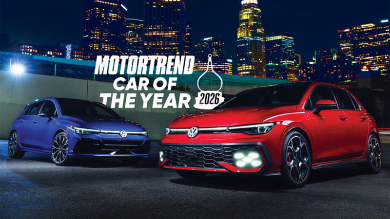 Dramatically lit night time shot of a Golf R shown in Lapiz Blue Metallic and a Golf GTI shown in Kings Red Metallic parked with a cityscape in the background and with an award logo superimposed on the image.