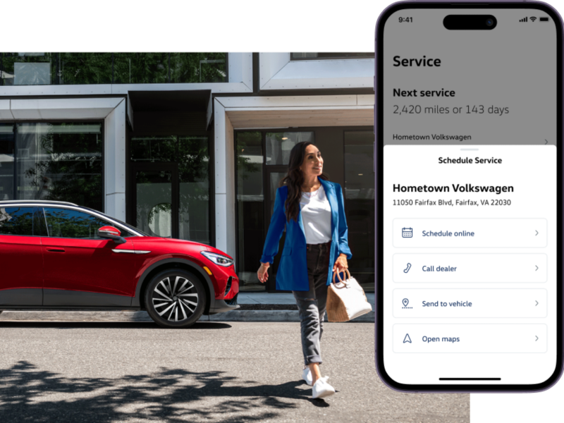 ID.4 shown in Arctic Blue Metallic driving on a modern city street, the myVW app is displayed on a superimposed mobile phone.