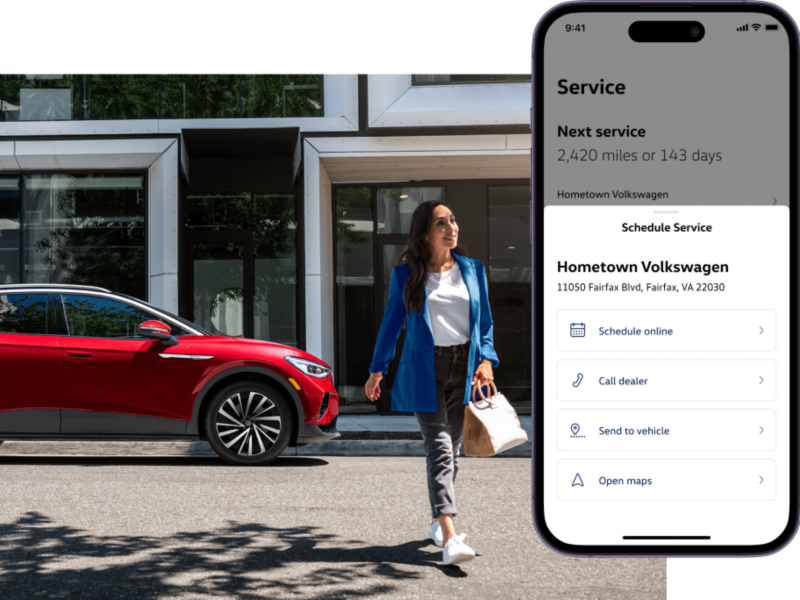 ID.4 shown in Arctic Blue Metallic driving on a modern city street, the myVW app is displayed on a superimposed mobile phone.