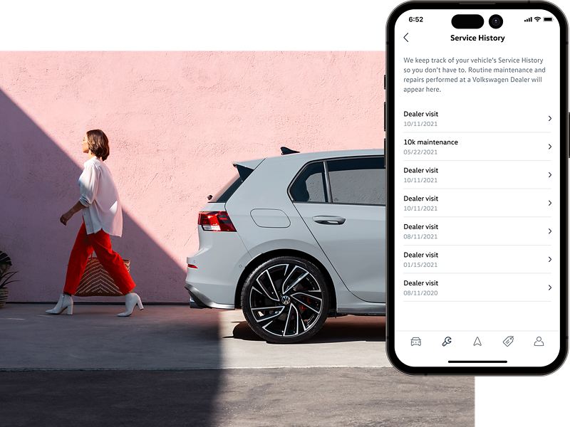 Golf GTI in Moonstone Gray parked next to a pink wall with a person walking away from the car. The MyVW app is displayed on a superimposed mobile phone.