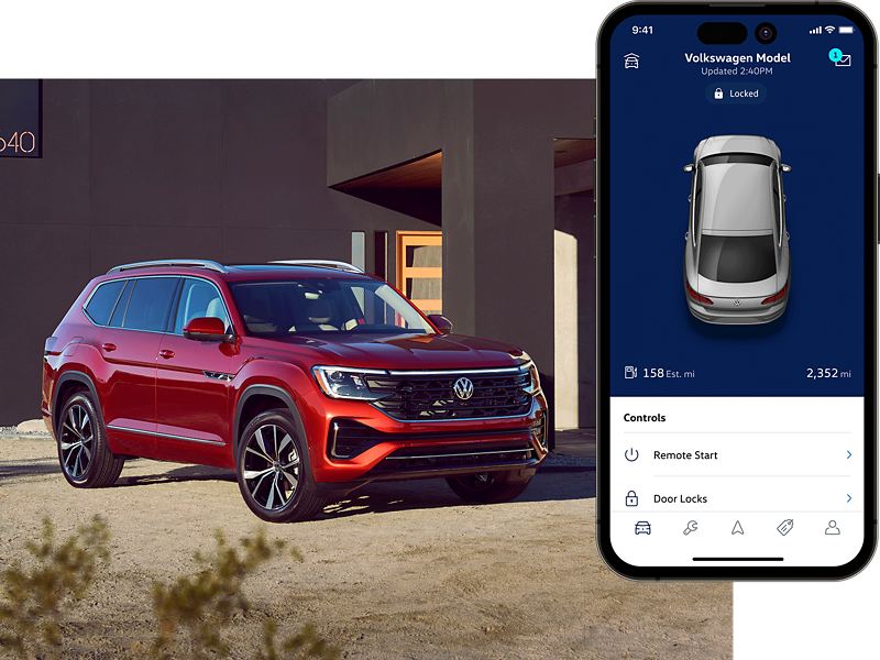Atlas shown in Aurora Red Metallic parked in front of a modern house in a desert setting. To the right, the MyVW app interface is displayed on a compatible phone.