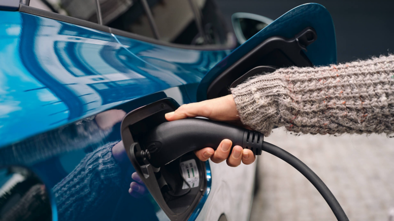 User charging their car with a plug