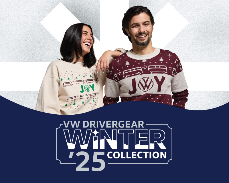 A smiling couple wearing Christmas sacks with the word Joy.