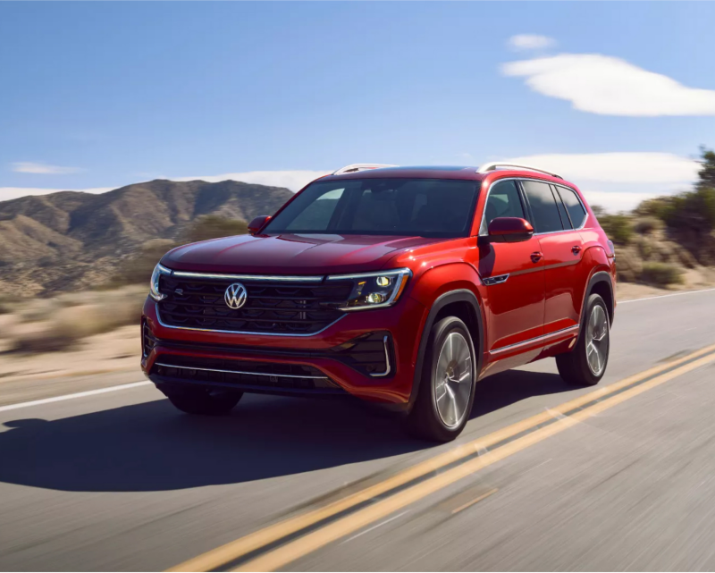 Red VW Atlas driving on a highway.