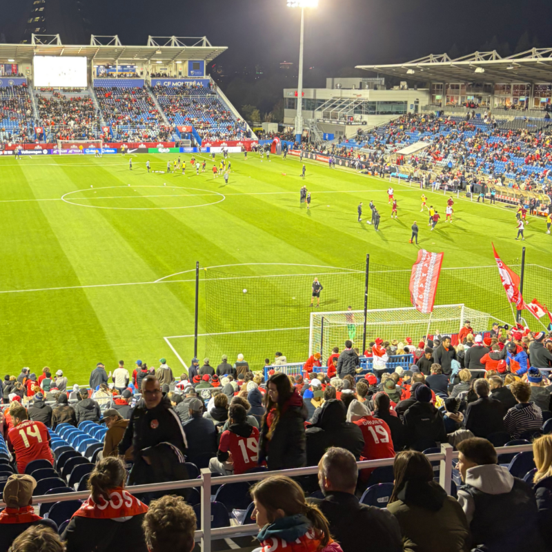 A wide shot from the stadium stands showing a full at BMO Field during the Australia vs. Canada soccer game. 