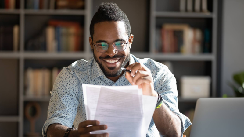 Man with documents and laptop