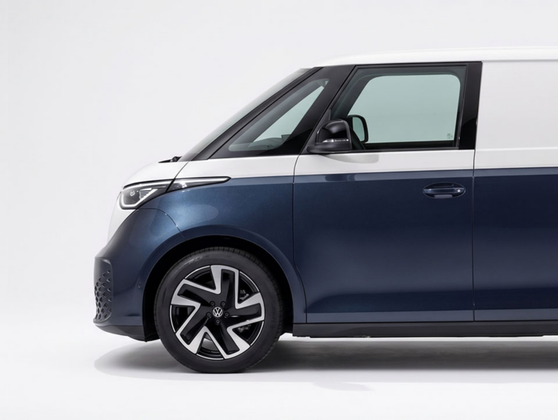 Zijaanzicht van de voorkant van een tweekleurige, wit met donkerblauwe elektrische Volkswagen ID. Buzz Cargo.