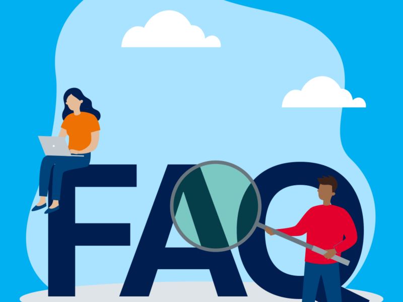 Two people in front of a FAQ sign