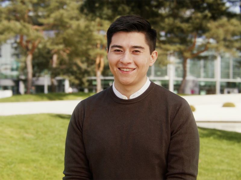 Young man in front of a building