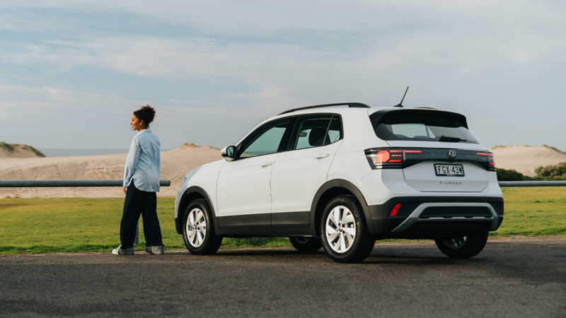 Woman standing next to white T-cross