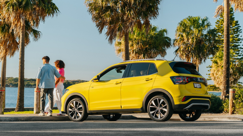 Woman standing next to the Boot door of the Volkswagen T-Cross.