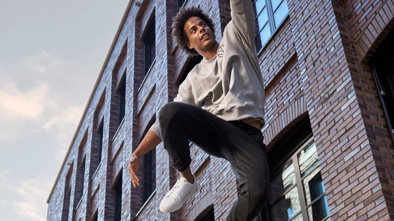 Man wearing a jacket from the GTI Collection jumping over a wall – VW Merchandise