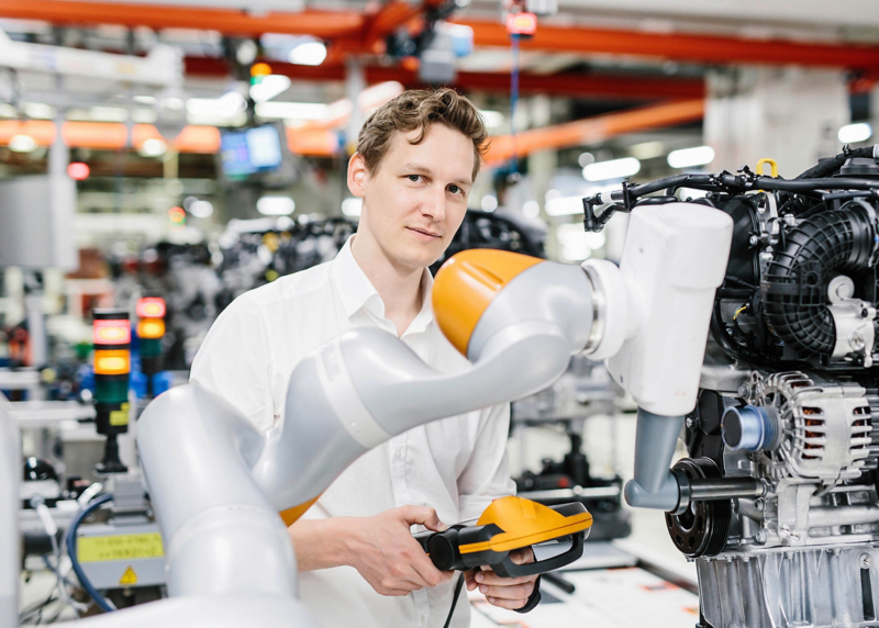 A man working on a robot arm