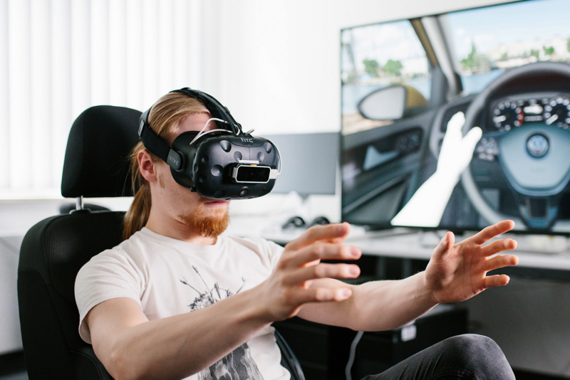 Young student with VR glasses in front of screen