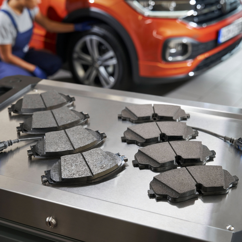 Volkswagen genuine break pads on mechanics table