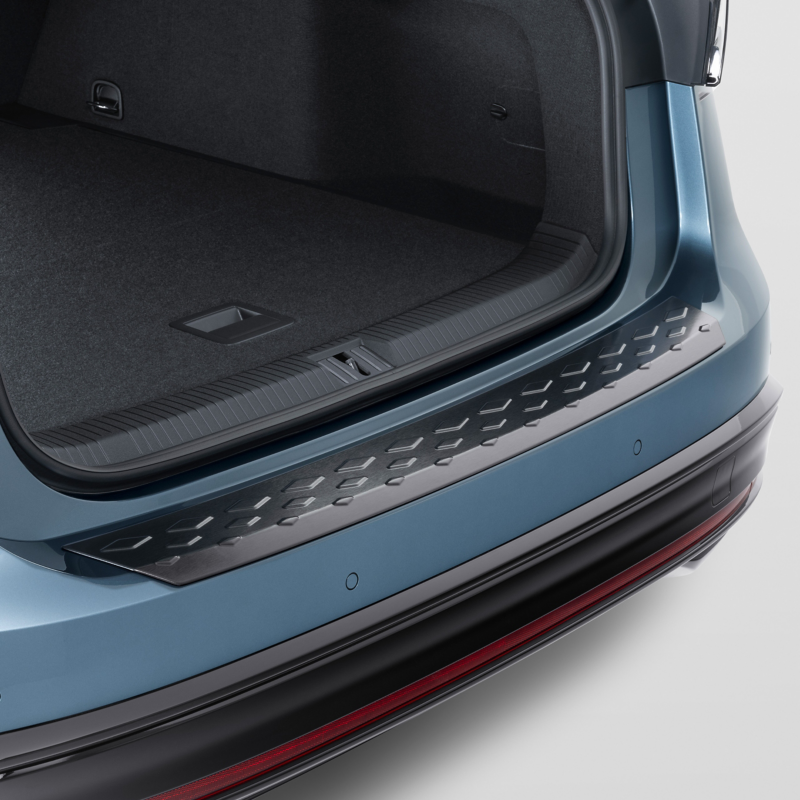 A silver VW vehicle with a folded down seat and open luggage compartment – packing correctly